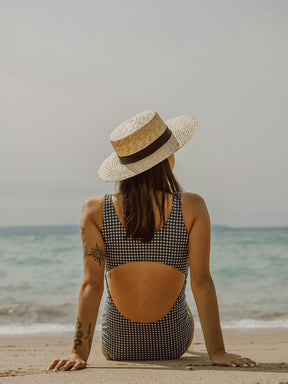 Lady sitting in the sun, protected by Koy natural sunscreen with no aluminium or toxins for safe, effective sun protection