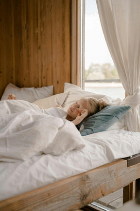 Girl sleeping peacefully with organic magnesium sleep balm for relaxation and restful sleep